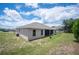 House exterior showcasing a large backyard and screened patio at 4046 Dinner Lake Way, Lake Wales, FL 33859