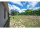 House exterior showcasing a large backyard and screened patio at 4046 Dinner Lake Way, Lake Wales, FL 33859