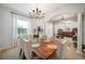 Elegant dining room with wood table and chandelier, open to living area at 4046 Dinner Lake Way, Lake Wales, FL 33859