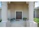 Double front doors with columns and a welcoming mat at 4046 Dinner Lake Way, Lake Wales, FL 33859