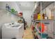 Spacious laundry room with washer, dryer, and ample storage shelving at 4046 Dinner Lake Way, Lake Wales, FL 33859