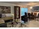 Elegant dining room adjacent to the living room, featuring a glass-top table and stylish chairs at 12609 Oulton Cir, Orlando, FL 32832