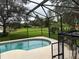 Screened pool area with backyard and lake view at 12609 Oulton Cir, Orlando, FL 32832