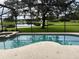 Relaxing pool and spa area with a view of a lake at 12609 Oulton Cir, Orlando, FL 32832