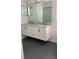 Double vanity bathroom with granite countertops and dark gray tile floor at 12609 Oulton Cir, Orlando, FL 32832