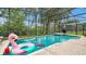 Inviting swimming pool with spa and inflatable flamingo at 7724 Comrow St, Kissimmee, FL 34747