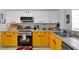 Bright yellow kitchen with stainless steel appliances at 7724 Comrow St, Kissimmee, FL 34747