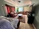 Living room with brown leather sofas and a large TV at 6004 Hilltop E Ln, Lakeland, FL 33809