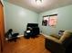 Bright home office features wood flooring, window, and comfortable seating at 6004 Hilltop E Ln, Lakeland, FL 33809