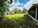 Large backyard with grassy area and screened enclosure at 6004 Hilltop E Ln, Lakeland, FL 33809