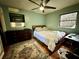 Cozy bedroom with wood flooring, dresser and a comfortable bed at 6004 Hilltop E Ln, Lakeland, FL 33809