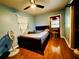Bedroom with a double bed, fan, and wood flooring at 6004 Hilltop E Ln, Lakeland, FL 33809