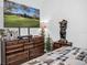 Bedroom with dresser, large TV, and bear statue at 7474 Sw 78Th Ter, Ocala, FL 34481