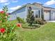 House exterior showcasing a light blue color scheme and landscaping at 7474 Sw 78Th Ter, Ocala, FL 34481