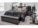 Main bedroom with king-size bed and exercise bike at 7474 Sw 78Th Ter, Ocala, FL 34481