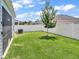 Spacious backyard with grassy lawn, white vinyl fence, and detached shed at 7474 Sw 78Th Ter, Ocala, FL 34481