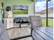 Relaxing screened porch with a TV and outdoor seating at 7474 Sw 78Th Ter, Ocala, FL 34481