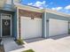 Two-car garage with stone and blue siding accents at 7474 Sw 78Th Ter, Ocala, FL 34481