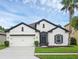 Charming single-story home with white exterior and black accents at 1126 Whitewater Bay Dr, Groveland, FL 34736