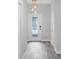 Bright entryway with gray tile floors and a stylish light fixture at 1126 Whitewater Bay Dr, Groveland, FL 34736