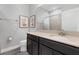 Modern bathroom with dark vanity, tile floor, and shower at 1126 Whitewater Bay Dr, Groveland, FL 34736