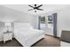 Bright bedroom with a king-size bed, nightstand, and ceiling fan at 1126 Whitewater Bay Dr, Groveland, FL 34736