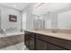 Elegant bathroom with double vanity, soaking tub, and walk-in shower at 1126 Whitewater Bay Dr, Groveland, FL 34736