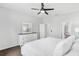 Spacious bedroom with white dresser, king bed, and ensuite bathroom access at 1126 Whitewater Bay Dr, Groveland, FL 34736