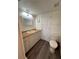 Bathroom features a toilet and updated flooring at 2729 N Poinciana Blvd # 117, Kissimmee, FL 34746
