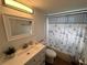 Clean bathroom with white vanity and nautical shower curtain at 2729 N Poinciana Blvd # 117, Kissimmee, FL 34746