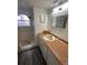 Bathroom with shower, vanity, and updated flooring at 2729 N Poinciana Blvd # 117, Kissimmee, FL 34746