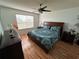 Spacious bedroom with wood floors and a ceiling fan at 2729 N Poinciana Blvd # 117, Kissimmee, FL 34746