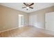 Spacious bedroom featuring light walls, ceiling fan, and ample closet space at 450 Avenue B Ne, Winter Haven, FL 33881