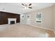 Living room features hardwood floors, a fireplace with wood accent wall, and ceiling fan at 450 Avenue B Ne, Winter Haven, FL 33881