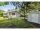 Spacious backyard, featuring a shed and partially fenced yard at 450 Avenue B Ne, Winter Haven, FL 33881