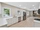 Modern kitchen with white cabinets, quartz countertops, and stainless steel appliances at 450 Avenue B Ne, Winter Haven, FL 33881