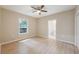Bright bedroom with new flooring, ceiling fan, and access to a private bathroom at 450 Avenue B Ne, Winter Haven, FL 33881