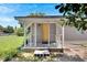 Inviting front porch with a yellow door and white railings at 2439 Lakeview St, Lakeland, FL 33801