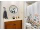 Clean bathroom with wood vanity and floral shower curtain at 4314 Ridge Rd, Lakeland, FL 33811