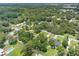 Aerial view showing a neighborhood with houses nestled amongst lush greenery, highlighting a quiet community atmosphere at 4314 Ridge Rd, Lakeland, FL 33811