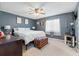Bright bedroom features a ceiling fan, large bed, and neutral color palette at 4314 Ridge Rd, Lakeland, FL 33811