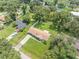 Aerial view showing a house with a large backyard and neighborhood homes, surrounded by lush greenery at 4314 Ridge Rd, Lakeland, FL 33811