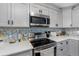 Stainless steel appliances and modern gray cabinets highlight this kitchen at 4314 Ridge Rd, Lakeland, FL 33811
