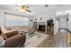 Bright living room featuring hardwood floors, fireplace, and ample natural light at 4314 Ridge Rd, Lakeland, FL 33811