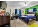 Bright bedroom with a green accent wall and a comfortable bed at 4314 Ridge Rd, Lakeland, FL 33811