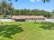 Spacious backyard showcasing a house's back elevation, lush lawn, and screened patio at 4314 Ridge Rd, Lakeland, FL 33811