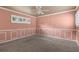 Spacious bedroom with neutral walls and carpeting, featuring wainscoting and a ceiling fan at 6318 Cedar Ln, Lakeland, FL 33813