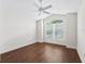 Bright bedroom with dark hardwood floors and a ceiling fan at 2316 Midnight Pass Ct, The Villages, FL 32162