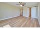 Spacious bedroom with laminate wood flooring and an ensuite bathroom at 7031 Red Grange Boulevard Ave, Indian Lake Estates, FL 33855