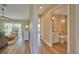 Clean bathroom with white vanity, toilet and bathtub, featuring light wood-look flooring at 7031 Red Grange Boulevard Ave, Indian Lake Estates, FL 33855